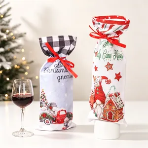 Detail of Christmas wine bottle gift bags with drawstring ribbons and festive patterns