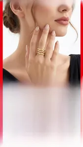 Close-up of golden crossover 925 silver ring with pavé moissanite on a model's finger