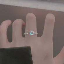 Detail of adjustable star and planet ring with iridescent finish on a hand