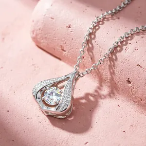 Macro detail of dancing heart waterdrop pendant with cubic zirconia on steel chain