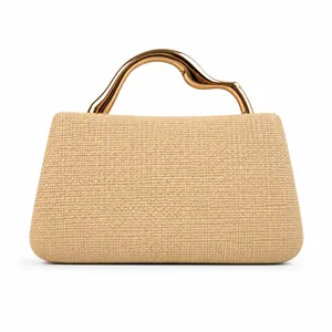 Detail of a woven straw handbag featuring a unique gold curved metallic handle for women