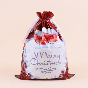 Close-up of red Christmas drawstring gift bag with Santa Claus cartoon and white ribbon