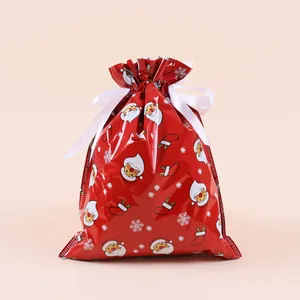 Detail of red Christmas drawstring gift bag with Santa and snowflake patterns