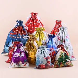 Detailed view of colorful Christmas drawstring gift bags with ribbons in various sizes