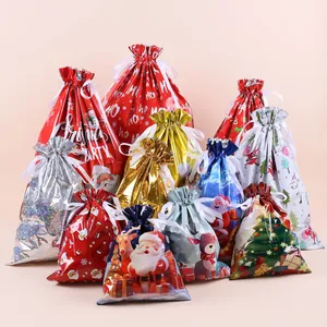 Detail of Christmas drawstring gift bags in assorted sizes with festive Santa and reindeer prints