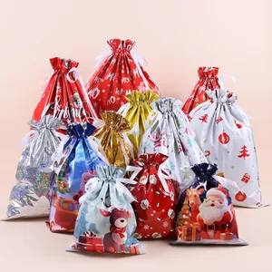 Close-up of festive drawstring gift bags in assorted sizes with glossy Christmas patterns
