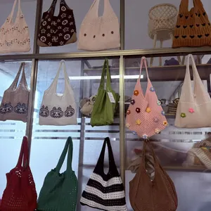 Detail of diverse handmade crochet tote bags with floral and geometric knitted patterns
