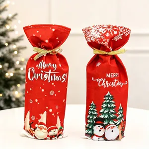 Detail of Christmas wine bottle bags with Santa and snowman motifs in red fabric