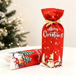 Red Christmas wine bottle gift bag with Merry Christmas print and golden ribbon