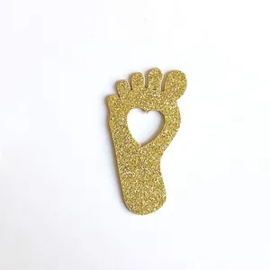 Golden glitter footprint paper confetti with heart cutout for baby shower table decor