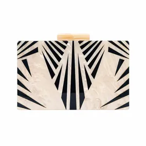 Art Deco acrylic clutch bag with pearl texture and black geometric sunburst pattern