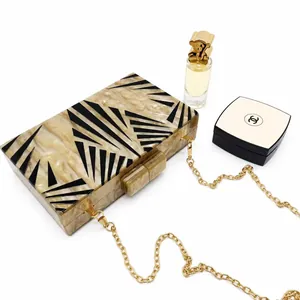 Retro marble pattern acrylic clutch bag with black geometric lines and gold chain strap