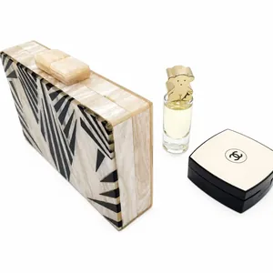 Detail view of acrylic zebra pattern evening clutch bag with black geometric marble textures