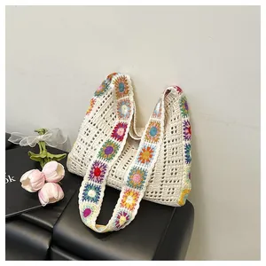 Detail of bohemian hollow knit granny square bag featuring colorful crochet sunflower patterns