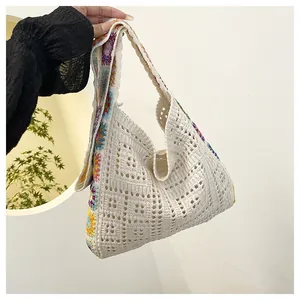 Close-up of bohemian hollow crochet bag with rainbow floral granny square patterns