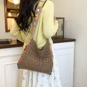 Bohemian crochet knit crossbody bag with colorful floral patterns and hollow design
