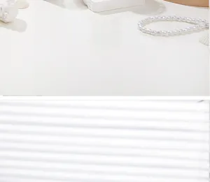 Artistic layout of round white pearl necklace with shells and shadow details