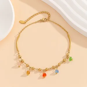 Detailed macro view of gold titanium steel bracelet with five colorful crystal pendants