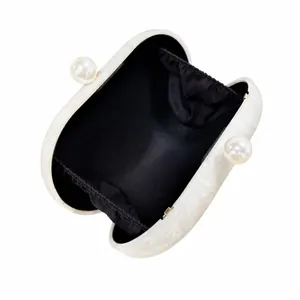 White marble acrylic evening clutch bag with pearl clasp shown open on white background