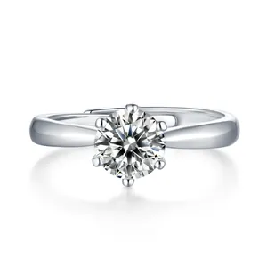 Minimalist six-prong moissanite engagement ring with round cut stone and open silver band