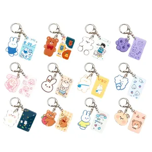 Set of 12 cute acrylic keychains featuring cartoon bears, rabbits, and girls in 4x3 grid