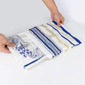Detailed view of Tallit prayer shawl with blue stripes, gold embroidery, and Tzitzit tassels
