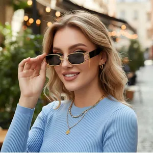 Fashionable rectangle metal sunglasses with gold frame and black lenses on female model