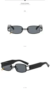 Detail of black rectangular sunglasses with C1 model code and gold metal ring accent