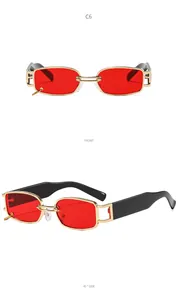 Detail view of retro narrow rectangle sunglasses with red lenses and gold ring charm