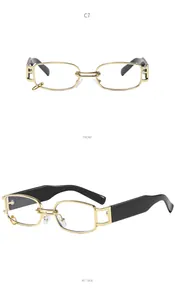 Close-up of small square metal sunglasses with a hanging gold ring and black temples