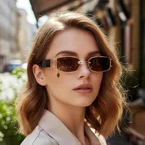 Chic gold metal rectangular sunglasses with dark lenses and unique circle charm detail