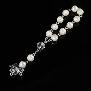 Detail of rose carved white beads with crystal accent and silver butterfly charm