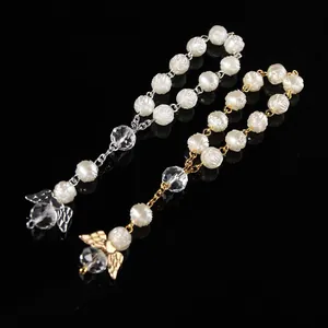 Detail of rose carved beads with angel wing charms in gold and silver finish