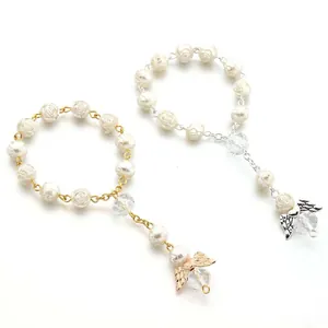 Elegant beaded bracelet with rose charms, angel wings and pearls in gold and silver finish