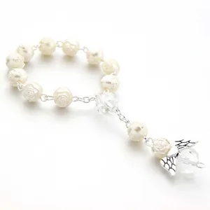 Detail of white rose relief beads with crystal accents and silver butterfly charm