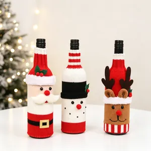Close-up of knitted Christmas wine bottle covers with Santa, snowman and elk designs
