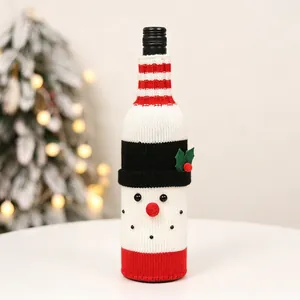 Close-up of a knitted snowman wine bottle cover with festive red and white details
