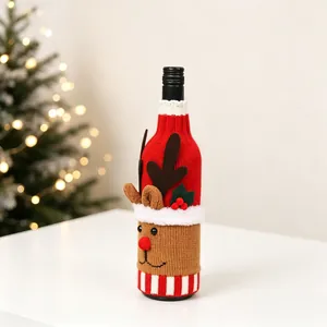 Detail of Christmas knitted wine bottle cover featuring a reindeer head and cozy wool texture