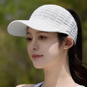Detailed knit texture of a white hollow-out visor cap for outdoor sun protection