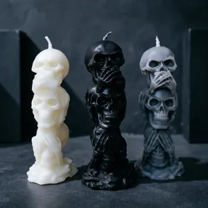 Three-stacked skull candles in black, white, and gray for Halloween decor