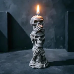 Detailed view of stackable grey skull candle with three skulls lit for dark gothic decor