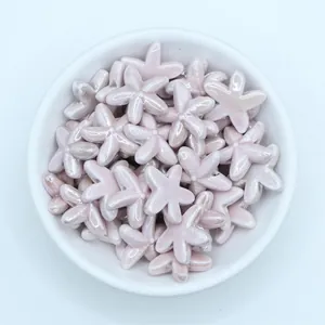 Close-up of glossy lavender starfish ceramic beads for DIY jewelry and crafts