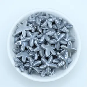 Macro detail of glossy starfish ceramic beads in a white bowl for DIY jewelry