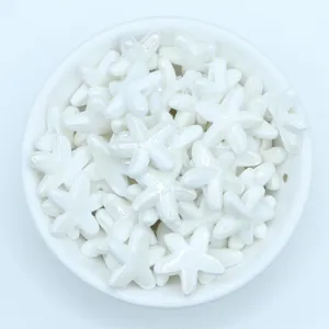 Macro shot of white glazed starfish ceramic beads for DIY jewelry making