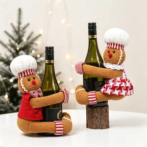 Close-up of cute gingerbread man and woman plush wine bottle covers for Christmas decor