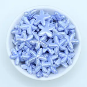 Macro shot of light blue starfish ceramic beads with pearlescent glaze for DIY jewelry