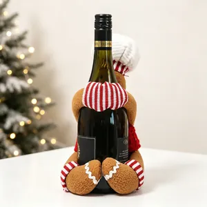 Detail of gingerbread man wine bottle cover with striped hat and knitted sweater decor