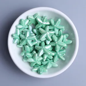 Macro view of mint green glazed ceramic starfish beads for handmade jewelry DIY