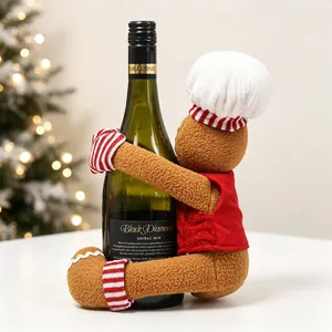 Detail of gingerbread man wine bottle cover with chef hat and red vest for Christmas