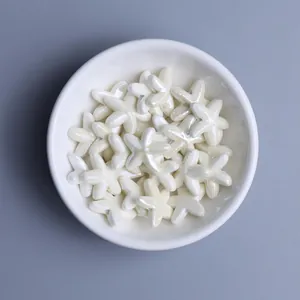 Macro shot of glazed starfish ceramic beads in a white bowl for DIY jewelry making